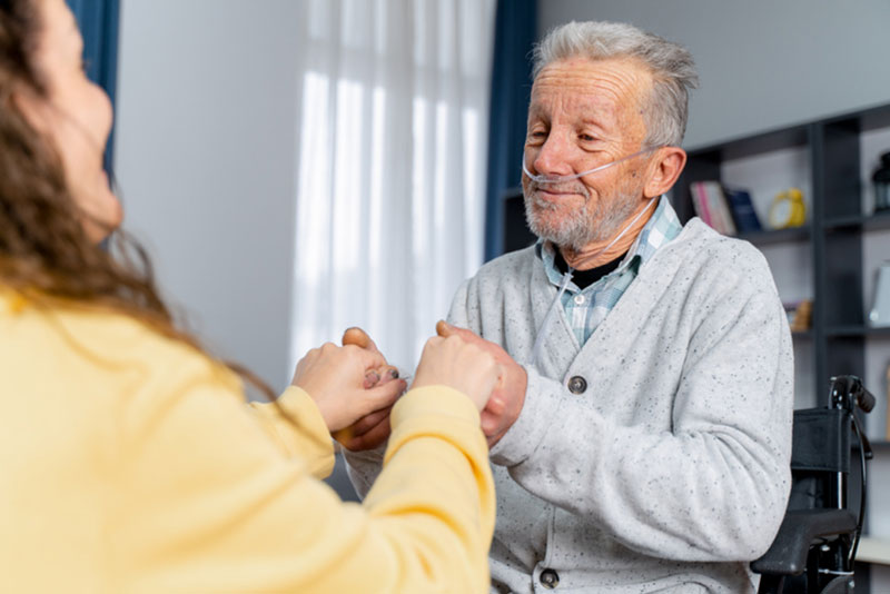 A woman demonstrates the impact that COPD caregivers have as she cares for her aging father who has COPD.